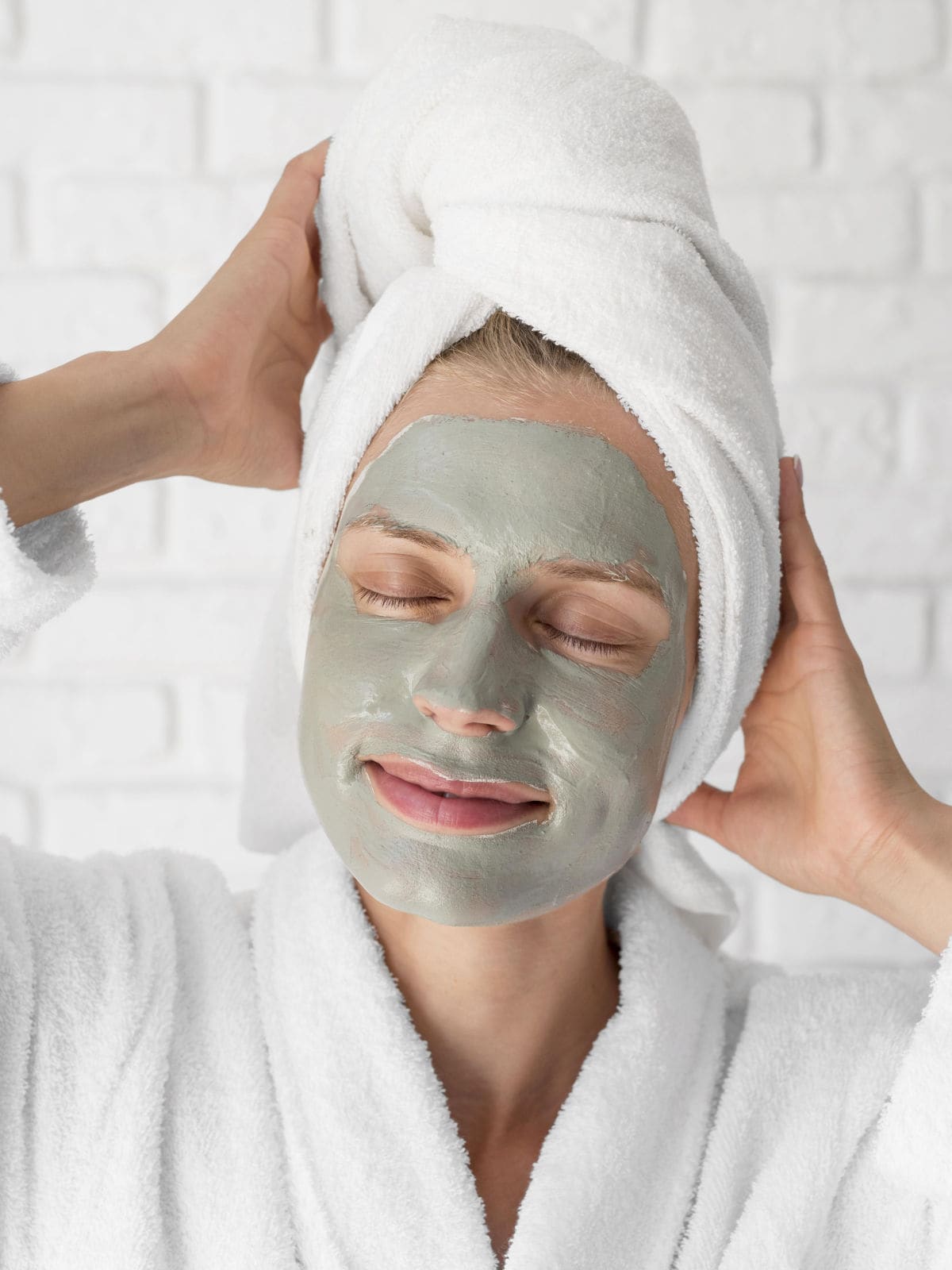 A woman with her face covered in homemade French green clay facial mask.