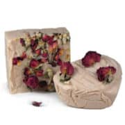 rose attar cold process soap with rose petals on top.