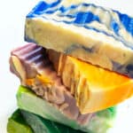 Stack of multi colored cold process soap made with a palm free oils formula.