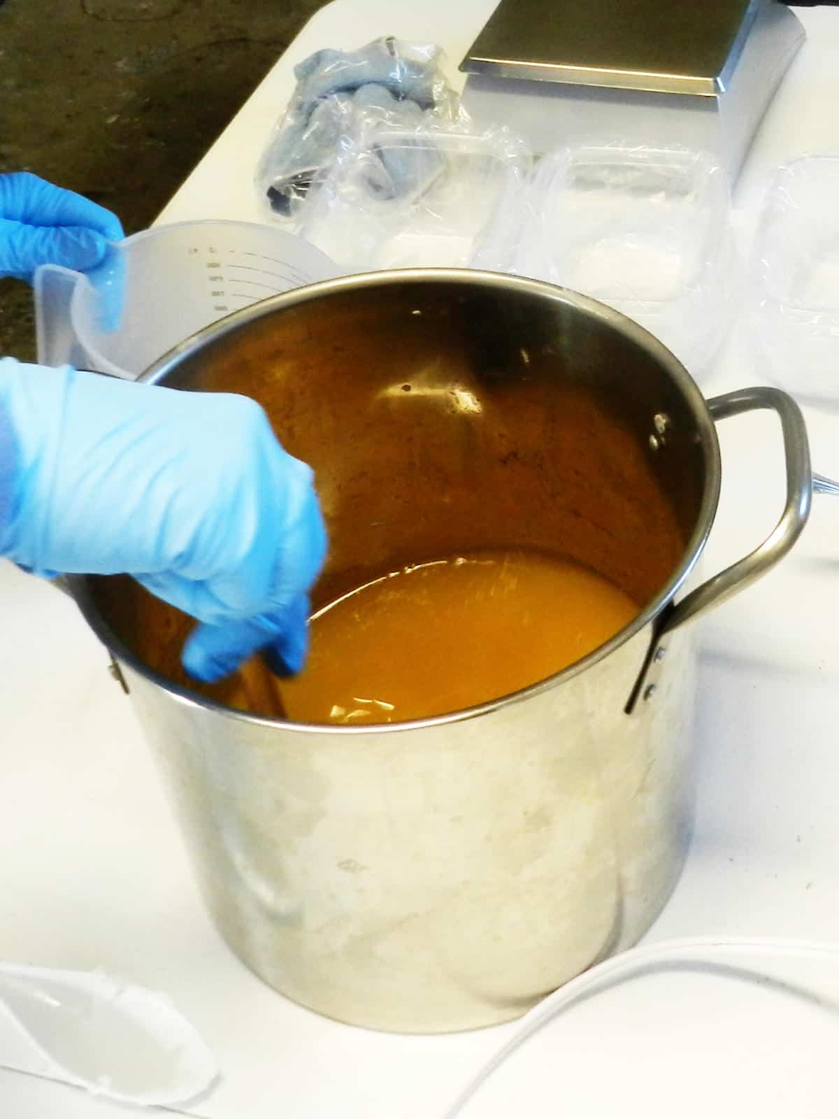 stirring in sodium hydroxide into a kettle of soap making oils.